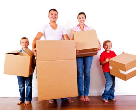 Movers carrying packed boxes during a Woolwich house move